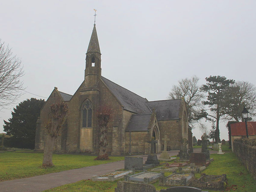 a traditional church building on a cludy day surrounded by a cemetery